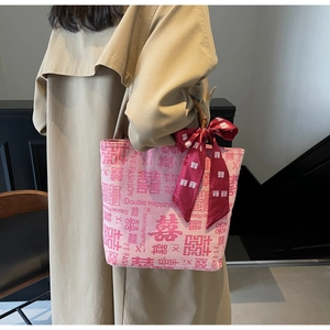 Chic pink bridal handbag featuring bamboo handles and red double happiness motifs