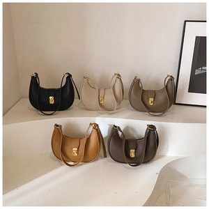 Detailed macro view of multi-color hobo bags in textured pebble leather with gold clasps