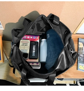 Interior view showing large capacity storage for tablet and clothes in black travel bag
