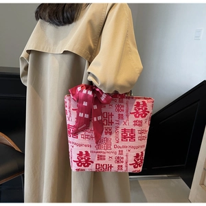 Detail of red wedding canvas tote bag with velvet bow and double happiness print