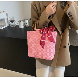 Pink jacquard tote with double happiness motifs, bamboo handles, and red ribbon bow detail