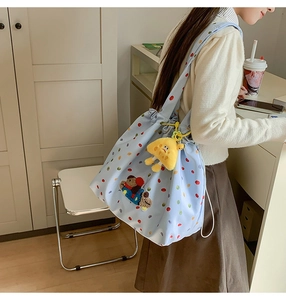 Detail of drawstring tote bag with colorful polka dots and cute bear embroidery