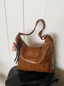 Brown vintage faux leather hobo shoulder bag with a cute plush bear pendant accessory