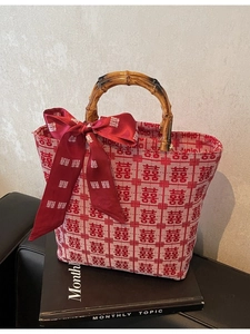 Elegant red wedding handbag with bamboo handle, woven texture and double happiness pattern