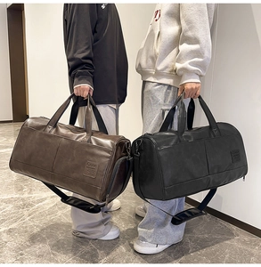 Detail of vintage PU leather travel bags with reinforced handles and brand logo texture