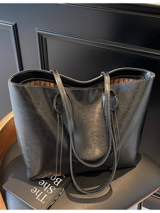 Classic black leather tote bag with white contrast stitching and spacious double handles