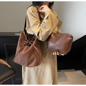 Detail of dark brown tote bag with a side bow and matching inner pouch set