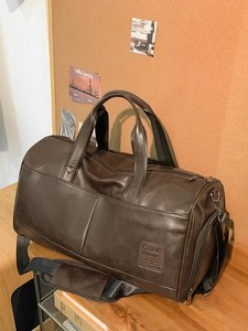 Retro large brown leather travel bag with adjustable shoulder strap and sturdy handles