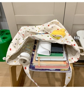 Internal view of a canvas tote bag showing high capacity with laptop and accessories