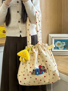 Polka dot canvas tote bag with plush bear patch and cute cartoon charm on handle