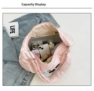 Pink quilted nylon tote bag interior showing large capacity for laptops and makeup