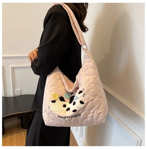 Detailed heart quilted nylon fabric on a pink tote bag with naughty puppy embroidery