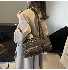 Detail view of a retro dark brown glossy bowling bag with double front zip pockets