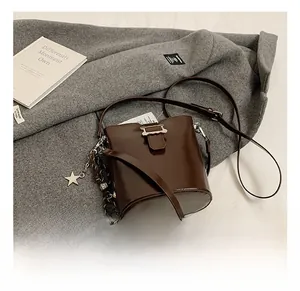 Détails du sac seau en cuir marron foncé avec boucle argentée et pendentif étoile
