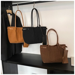 Detail of suede tote bags in black, coffee, and camel with matching zipper pouches