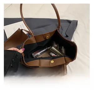 Interior view of large brown faux leather tote bag showing spacious storage capacity