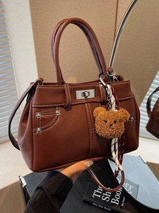 Retro brown leather tote bag with contrast stitching and decorative bear charm