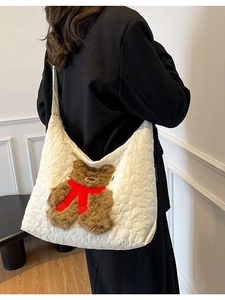 White quilted nylon tote bag with 3D teddy bear and floral embossing worn by a model