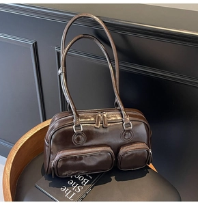 Close-up of retro coffee brown bowling bag with glossy texture and zipper pockets