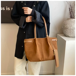 Vue détaillée du sac cabas en daim marron avec pochette assortie et coutures décoratives