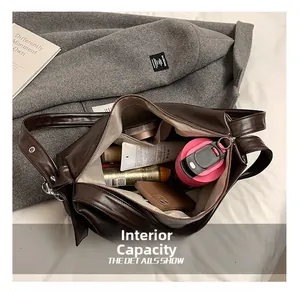 Internal capacity of brown vintage pillow bag showing makeup and water bottle inside