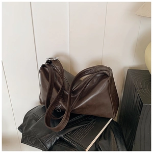 Macro shot of dark brown faux leather shoulder bag with sleek silver zipper detail