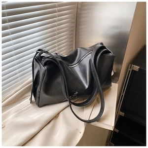 Detailed macro view of soft matte black leather texture and dual zipper hardware