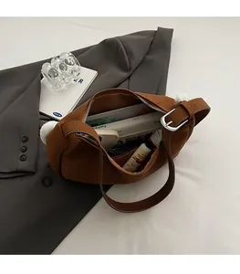 Interior view of brown suede shoulder bag showing large capacity for books and cosmetics
