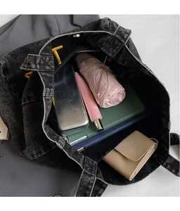 Top view of large capacity black denim tote bag with embroidery showing spacious interior
