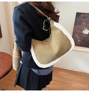 Detail of khaki hobo shoulder bag with fuzzy white plush trim and adjustable strap