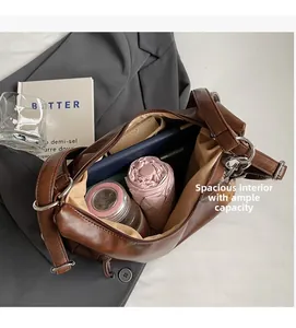 Spacious interior of brown faux leather tote bag holding an umbrella, water bottle, and tablet