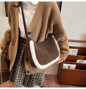 Detail of vintage matte crossbody bag with white faux fur trim and leather strap