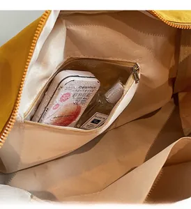 Detailed macro view of the waterproof wet and dry separation pocket inside the nylon tote