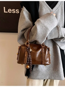 Retro dark brown bowling handbag in oil wax leather finish with woven pendant