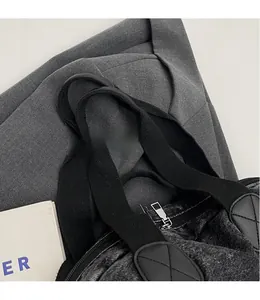 Detail of smooth shoulder straps and durable metal zipper on a large denim backpack
