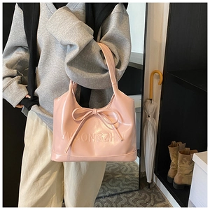 Pink tote bag detail showing large decorative bow and VWGONGZHU embossed logo on PU leather