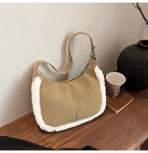 Detail view of khaki suede shoulder bag with plush white faux fur trim and adjustable strap