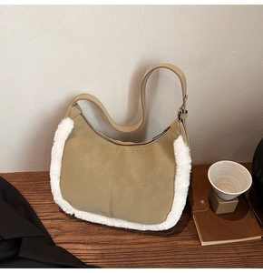 Detail view of khaki faux suede shoulder bag with white faux fur trim and zipper closure