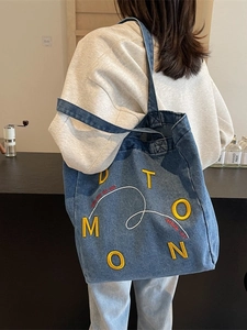 Large denim canvas tote bag with yellow embroidery and casual shoulder strap for commuting