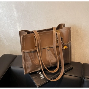 Detail of coffee brown tote bag with contrast stitching and clear PVC panel detail