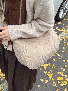 Fashionable beige quilted nylon tote bag with pleated texture for autumn winter fashion