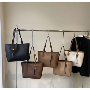Detailed display of minimalist large capacity tote bags in five different colors