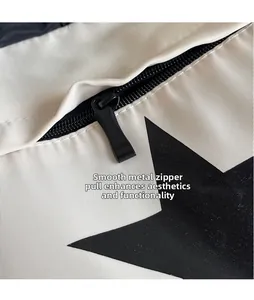 Dettaglio macro di una cerniera in metallo nero liscio su una borsa tote bianca a stelle