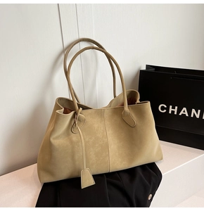 Close-up of beige matte suede tote bag showing soft texture and spacious interior