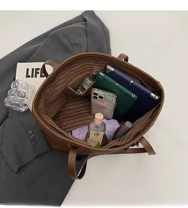 Interior view showing the large capacity of the brown tote bag for daily essentials