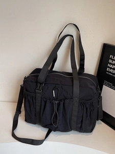 Black large capacity nylon tote bag with multi-pocket utilitarian design for commuting
