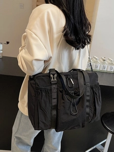 Large black nylon tote bag for women showing a minimalist urban style for commuting