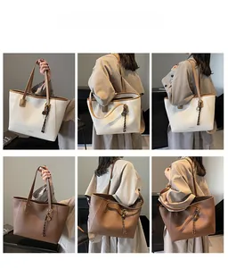 Litchi texture minimalist tote bag with shoulder strap and metal ring detail shown on model