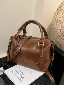 Vintage brown leather boston bag with contrast stitching and adjustable shoulder strap