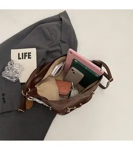 Detailed interior of brown leather tote bag showing spacious storage for tablet and wallet